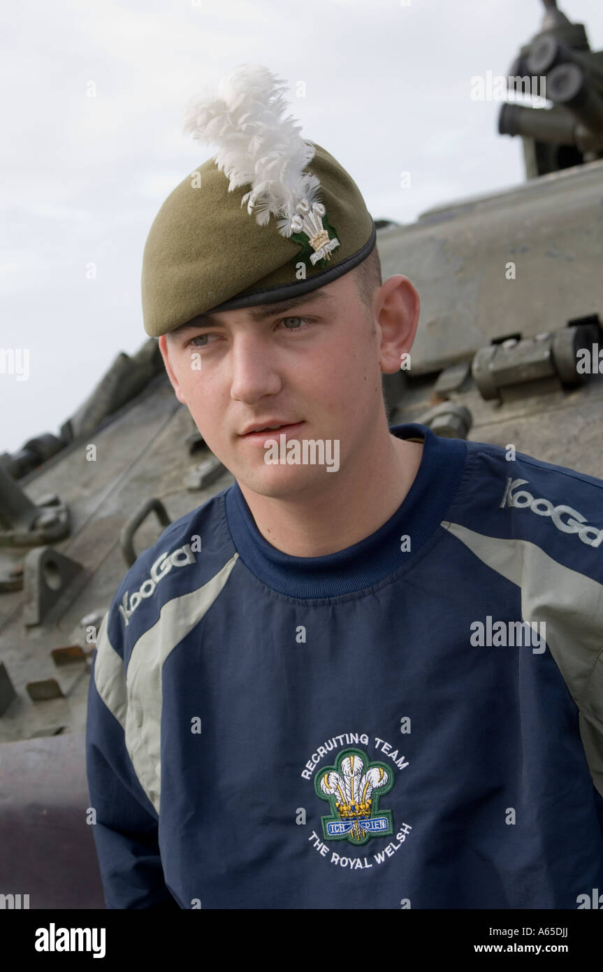 Young male soldier from the Royal Welsh regiment recruitment team standing in front of armoured personel carrier Stock Photo