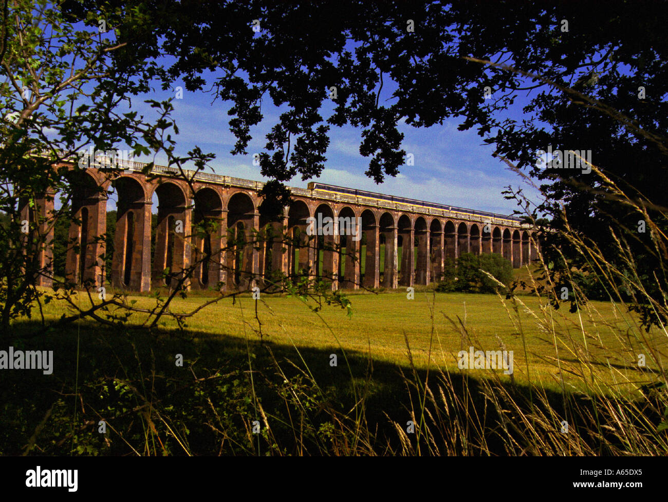 A Thameslink Brighton to Bedford train crossing the Ouse Valley Viaduct near Balcombe Sussex Stock Photo