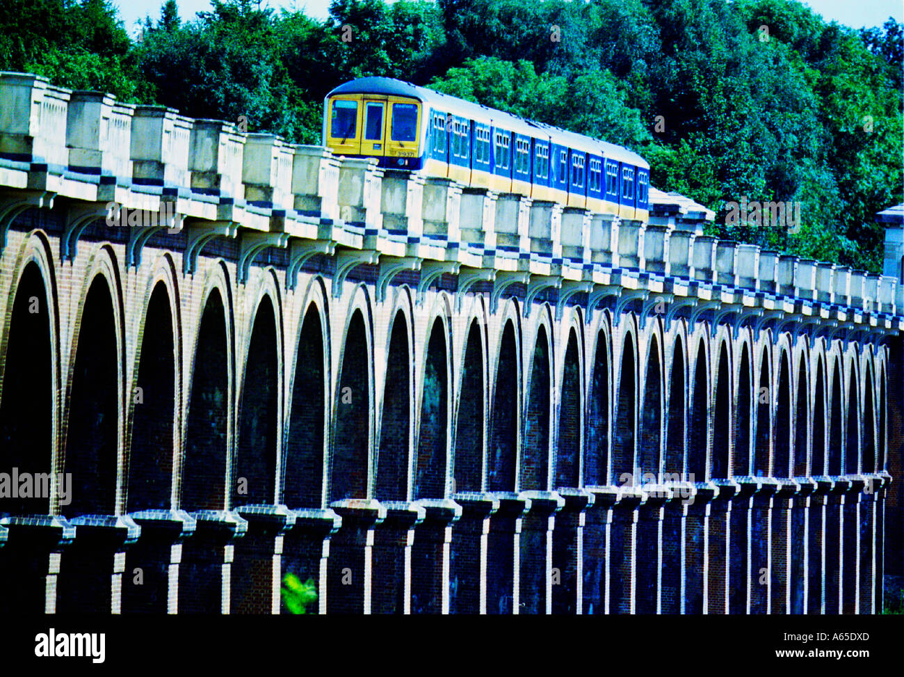 A Thameslink Brighton to Bedford train crossing the Ouse Valley Viaduct near Balcombe Sussex Stock Photo