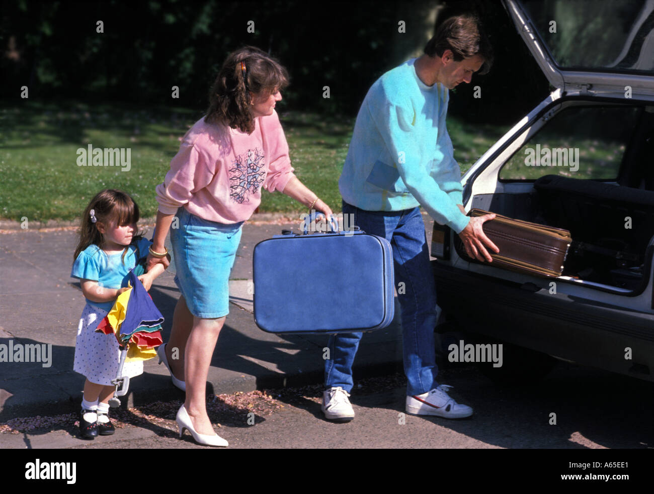 Family loading car with suitcases Stock Photo