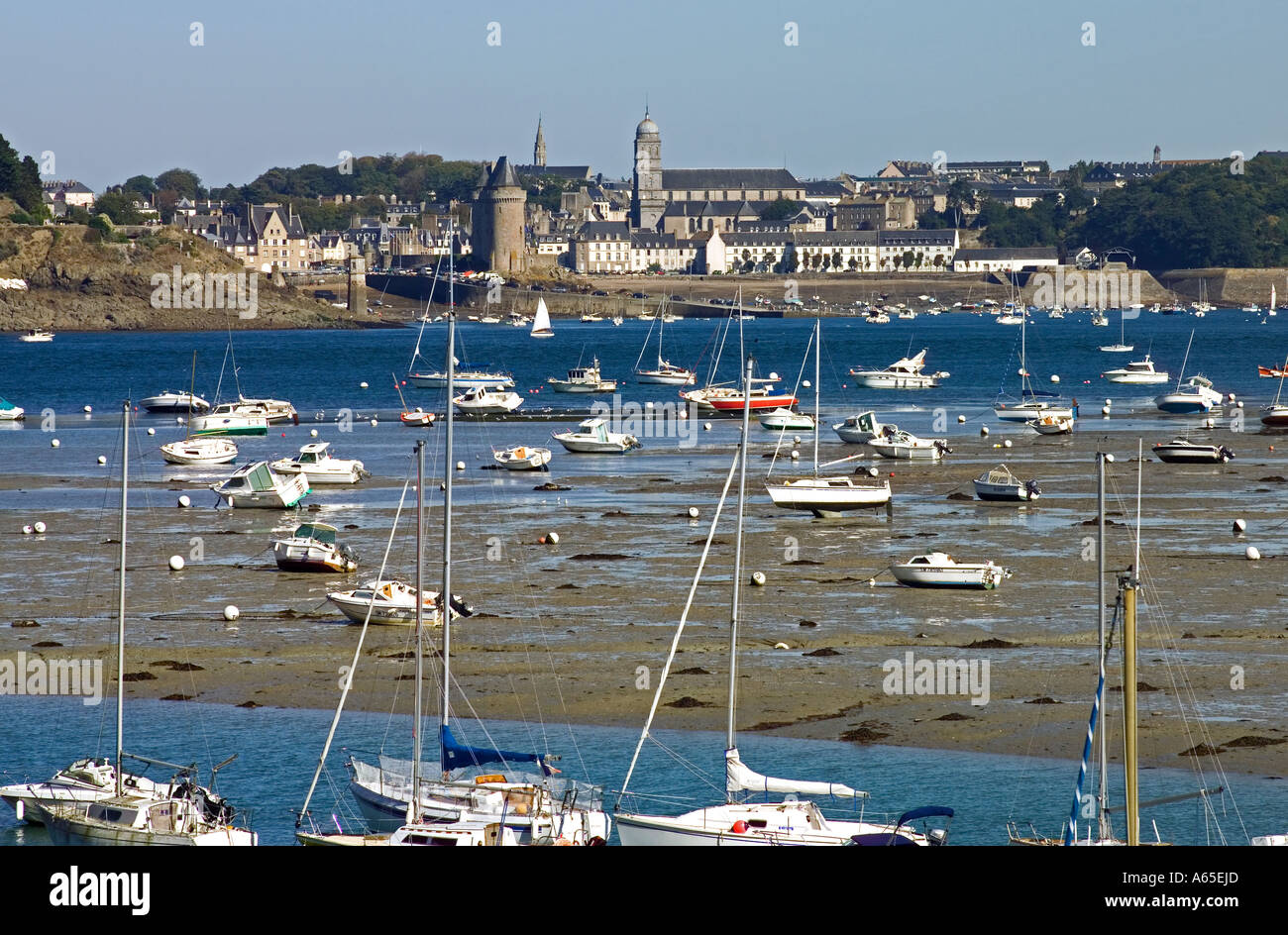 SAILBOATS AT  RANCE  RIVER ESTUARY AT LOW TIDE AND  SAINT-SERVAN-SUR-MER  SKYLINE BRITTANY FRANCE Stock Photo