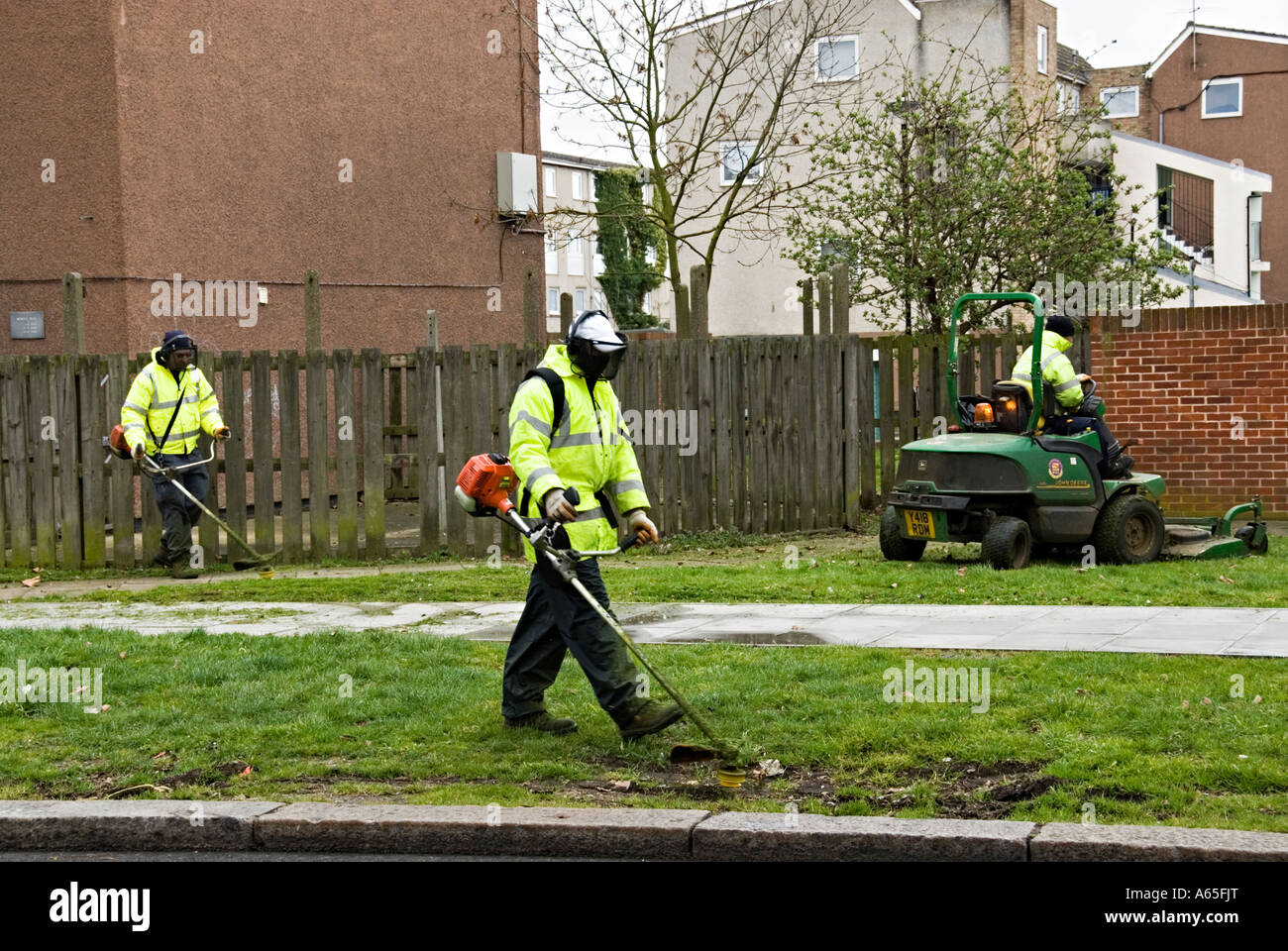 Council workers trimming verges using mechanical trimmers Stock Photo
