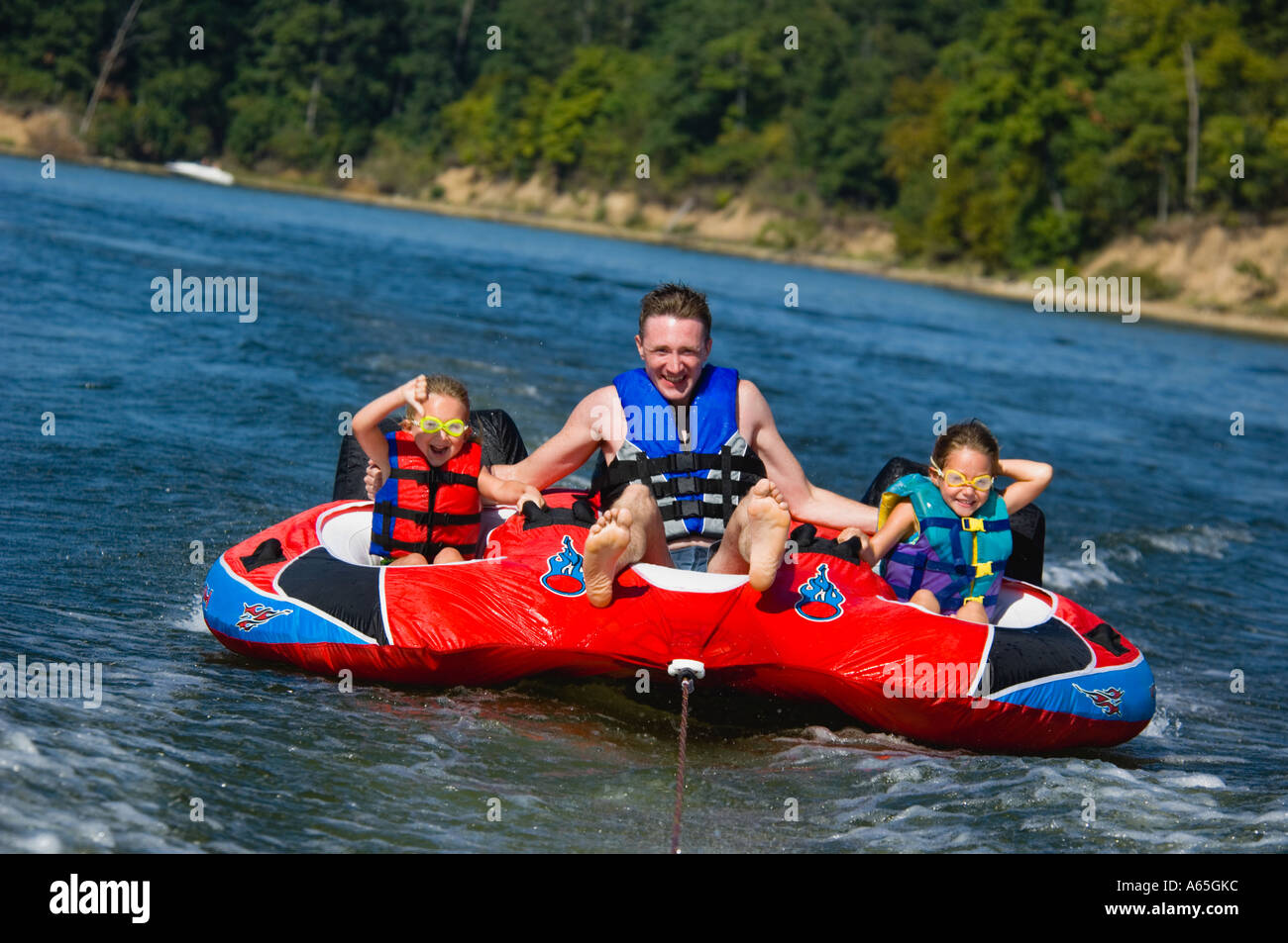Dad with kids on inner tube Stock Photo Alamy