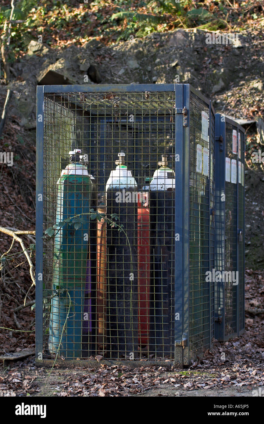 gas bottles stored in a metal cage Stock Photo