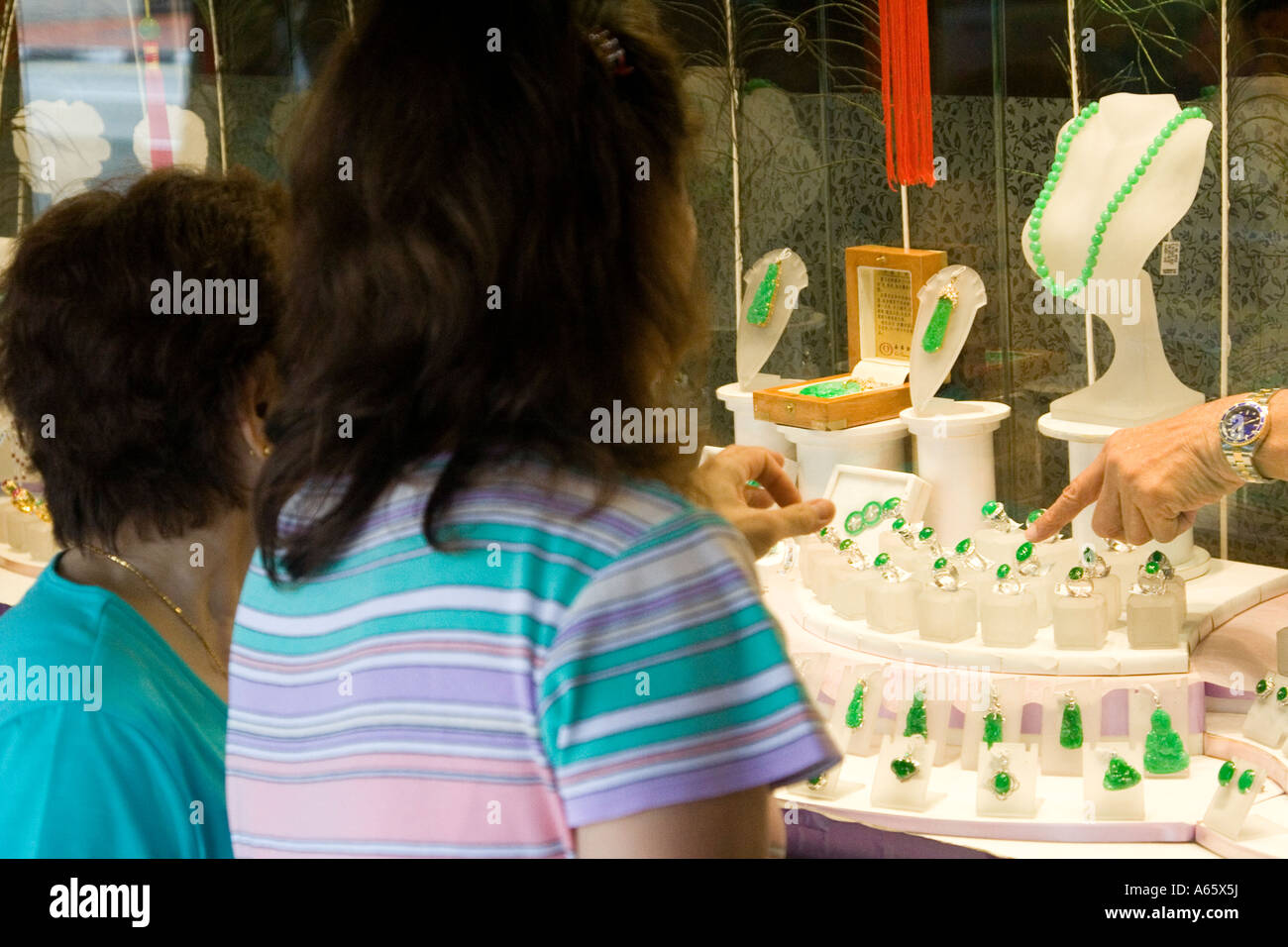 Women Indicating Jade Jewelry Selections through Shop Window Chinatown Singapore Stock Photo