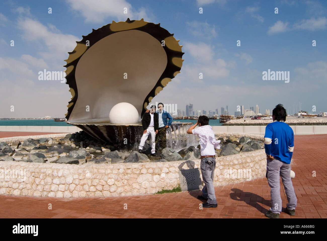 Migrant Workers Pose by Landmark Doha Qatar Stock Photo