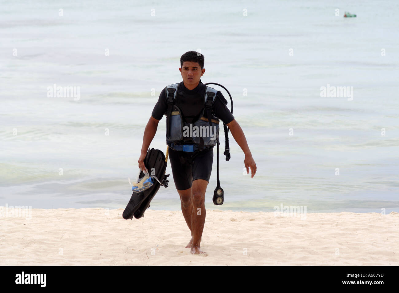 Scubadiver, man in scuba gear returns from diving in the waters off of the beach of Boracay, Philippine Islands Stock Photo
