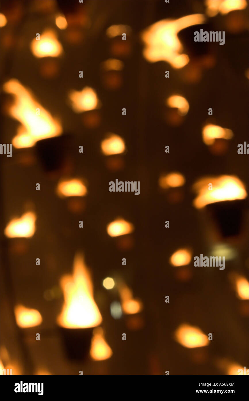 Orange and yellow 'out of focus' flames, fire sculpture glowing at night against [dark background], abstract light pattern Stock Photo