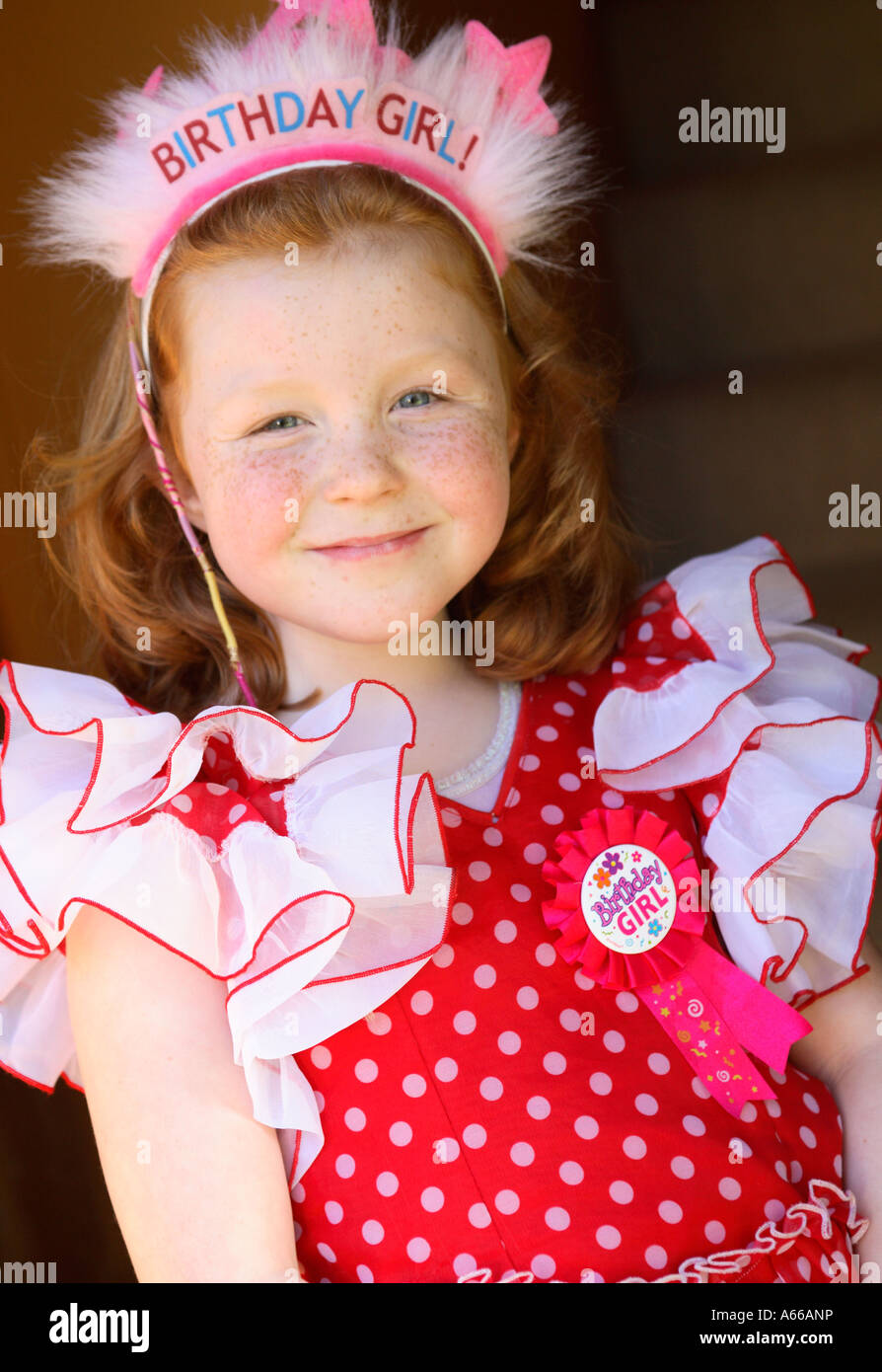 a small girl dressed up for her birthday party Stock Photo
