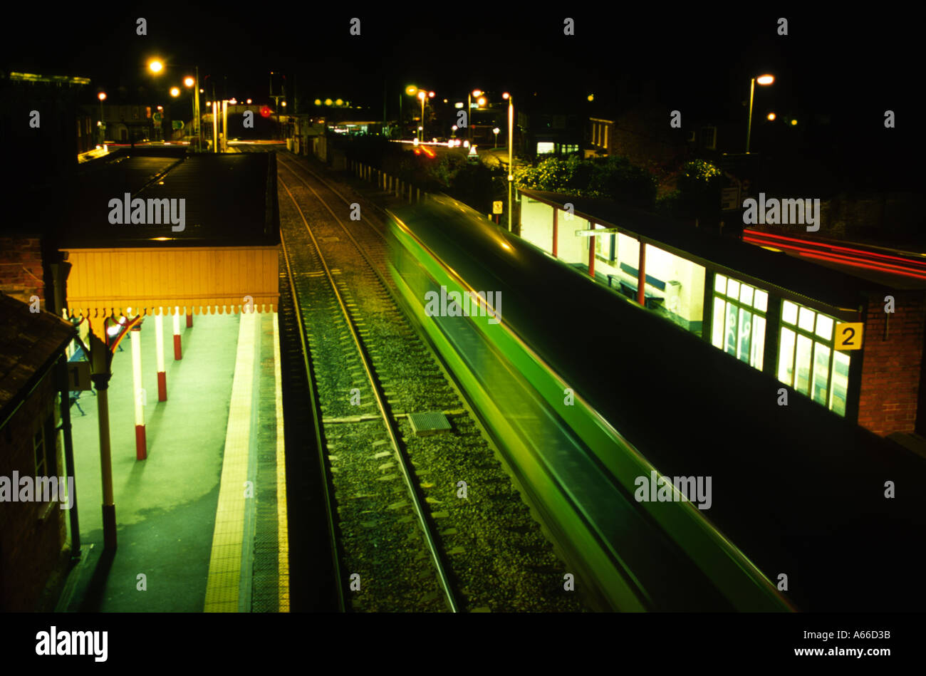 Railway station at night with blurred train in motion Central Trains