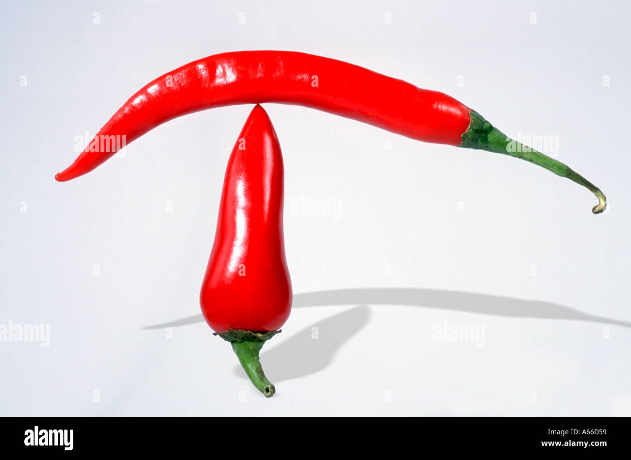 Chili peppers balancing Stock Photo