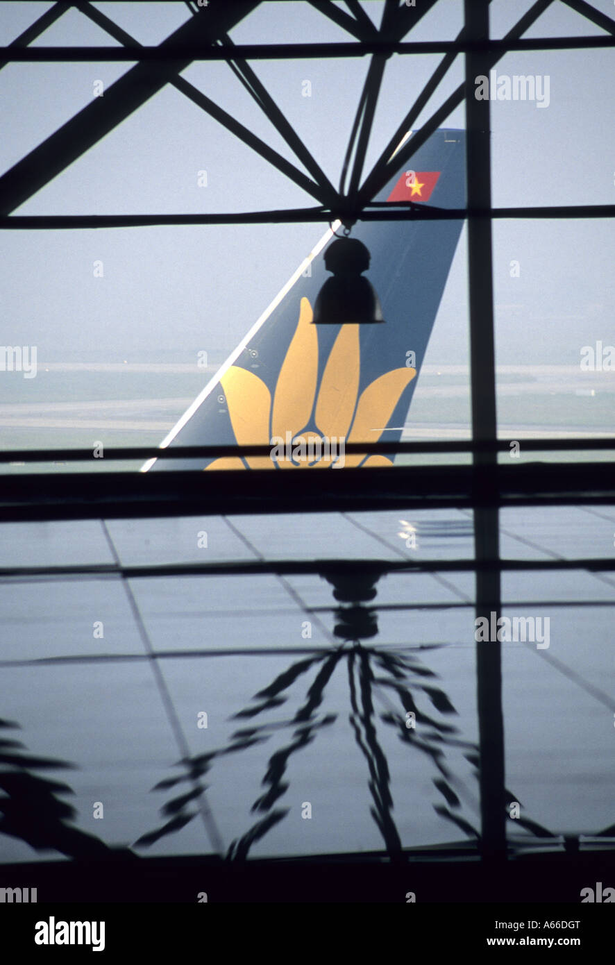 Logo on the tail of an aircraft of Vietnam Airlines seen from the transit hall of Hanoi Noibai Airport Stock Photo