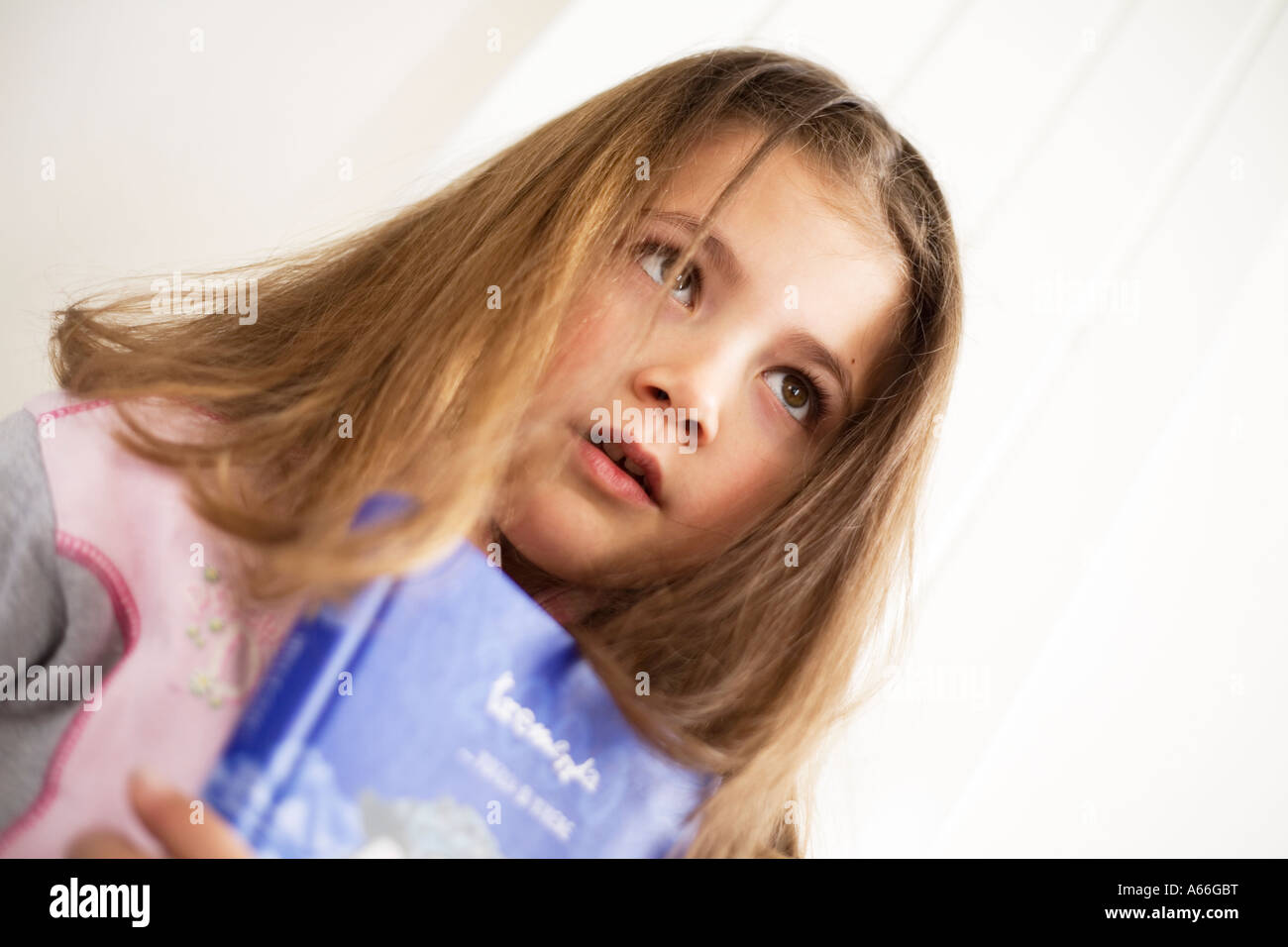 Schoolgirl holding a book Stock Photo - Alamy