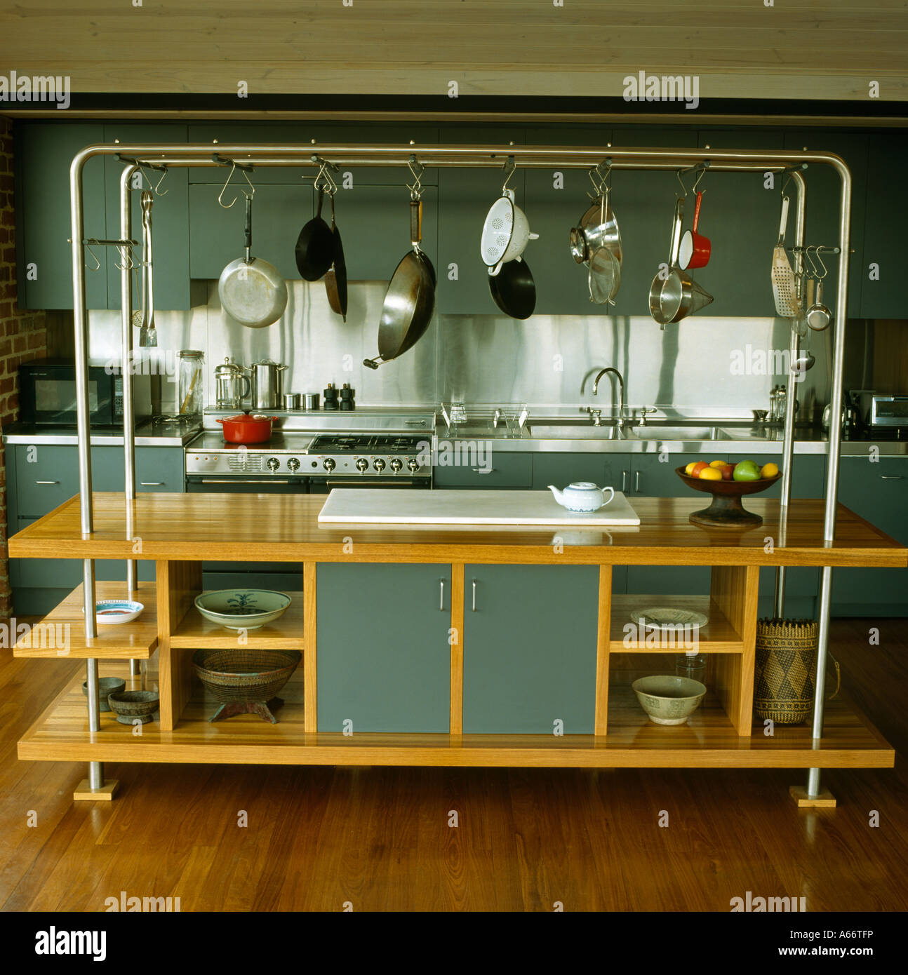 Freestanding shelf unit with hanging pans and hotplate Stock Photo