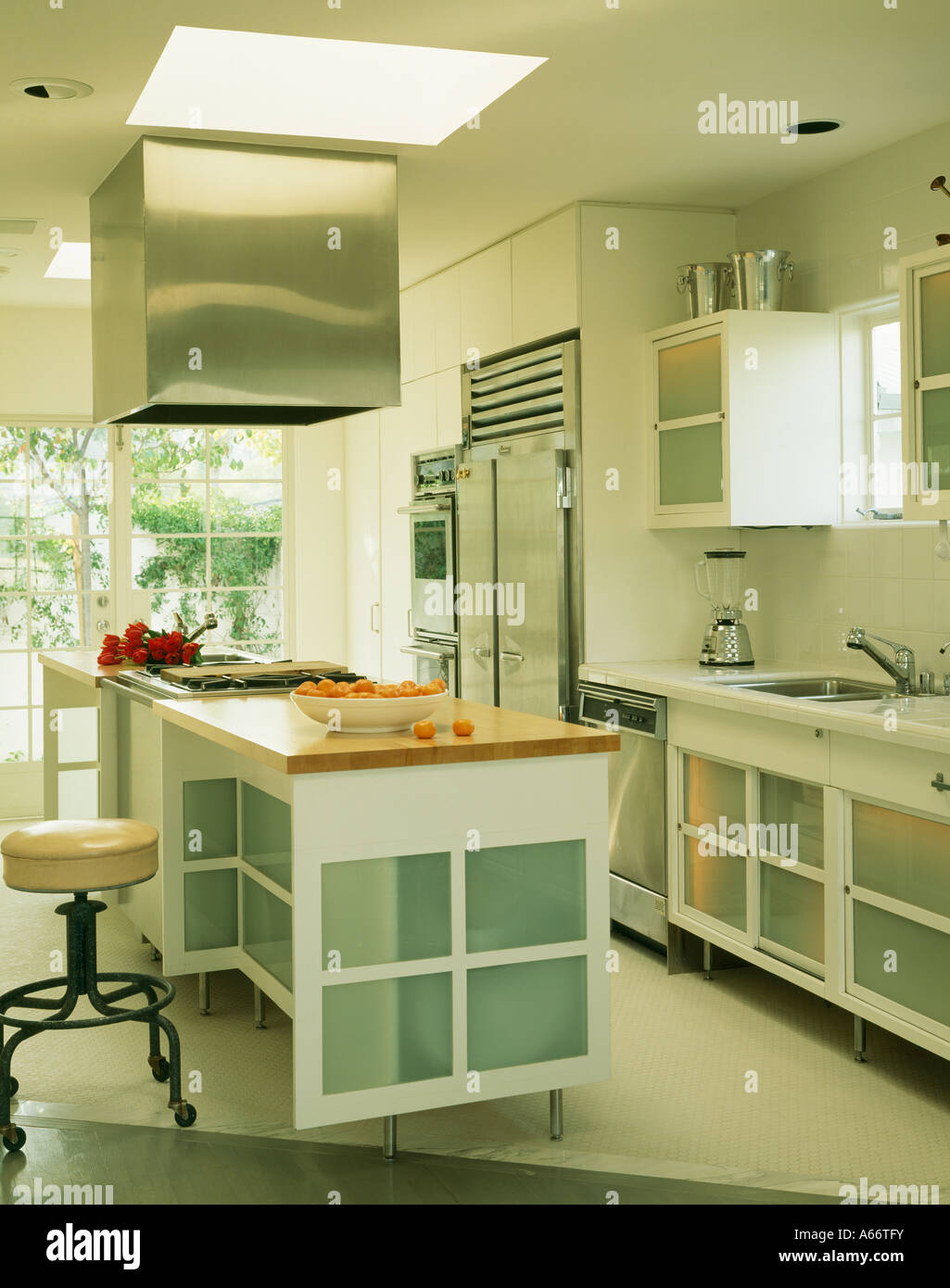 Modern White Kitchen With Island Unit And Opaque Glass Panels In