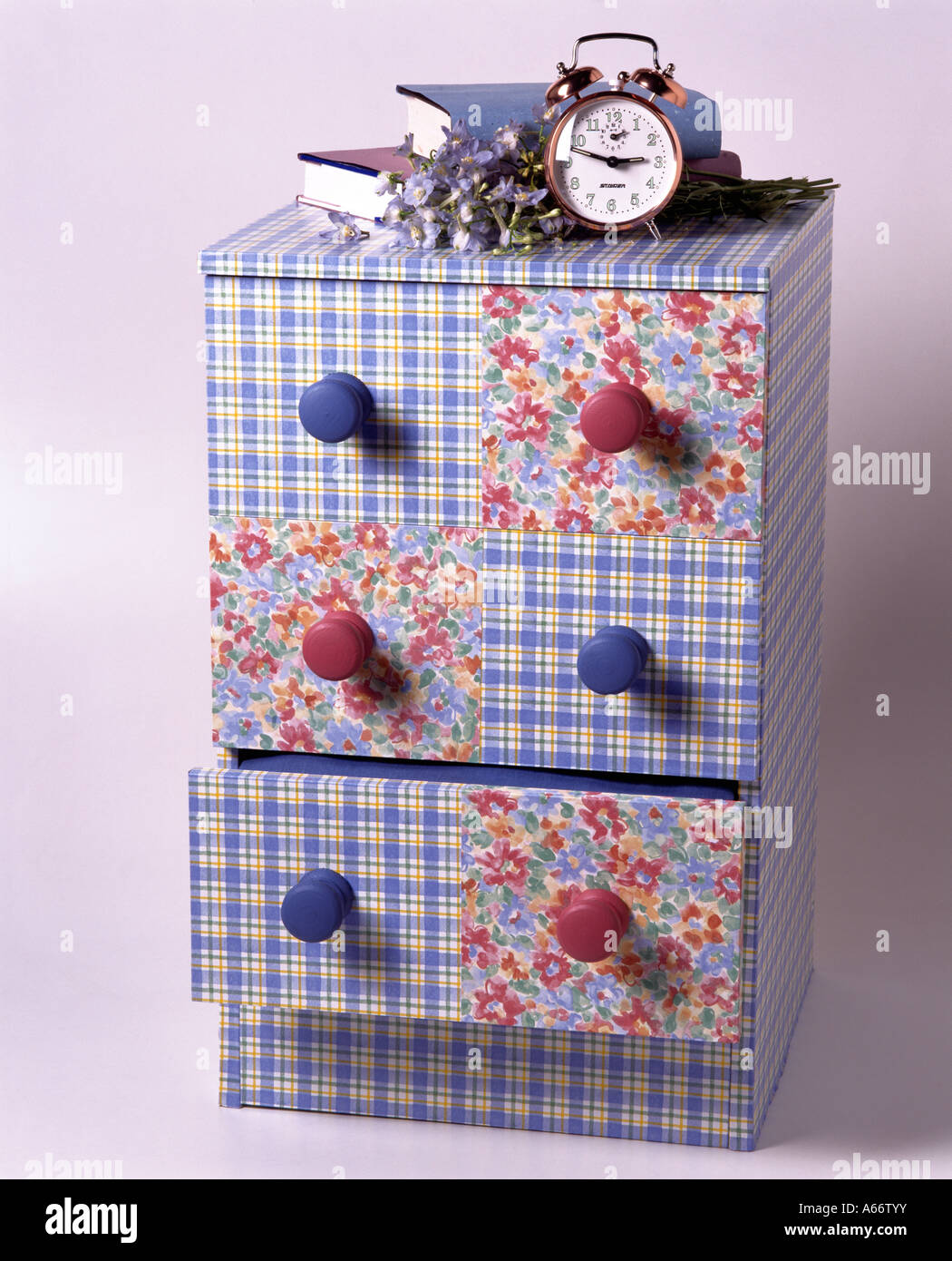 Clock On Small Chest Of Drawers Covered With Blue Check And Red