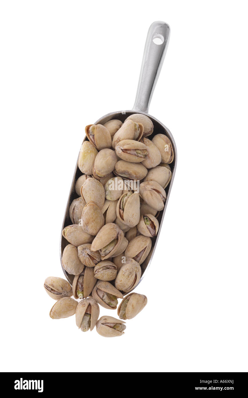 Scoop of pistachios cut out on white background Stock Photo