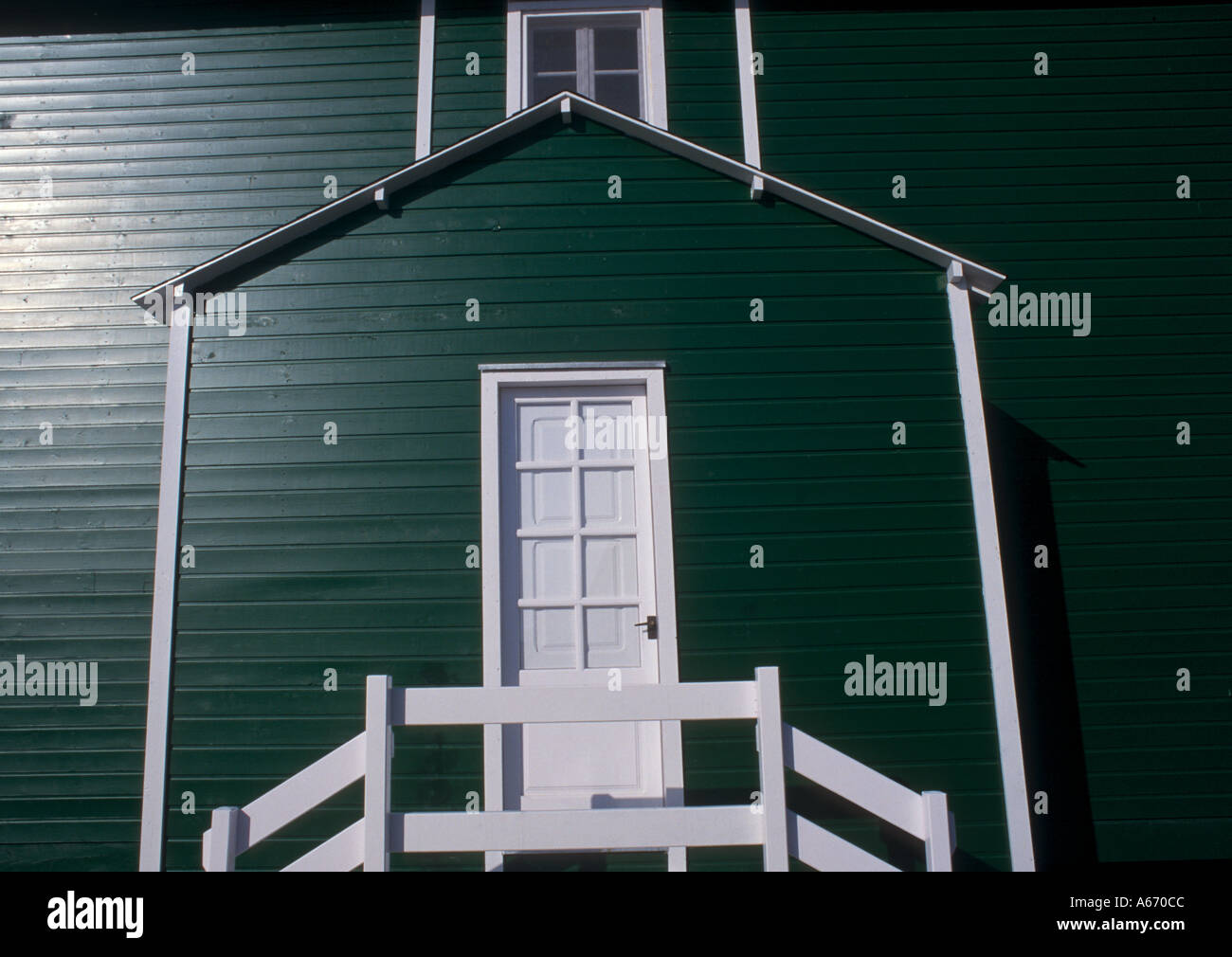 Green painted wooden building front entrance with white door Stock ...