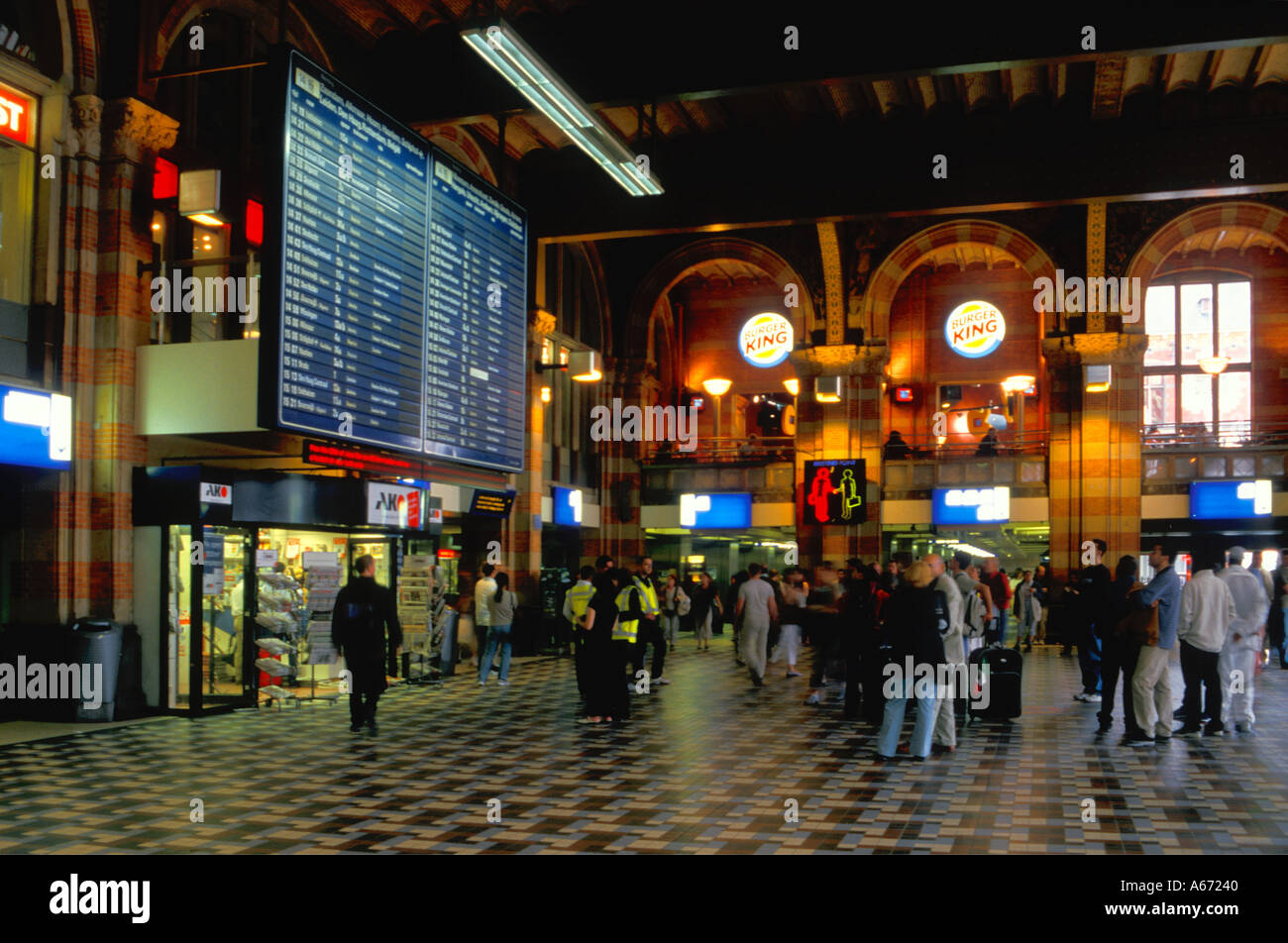 Railway Central Station Amsterdam people staring at itinerary screen