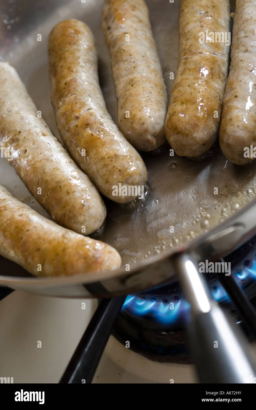 little pork sausage links frying in a pan Stock Photo Alamy