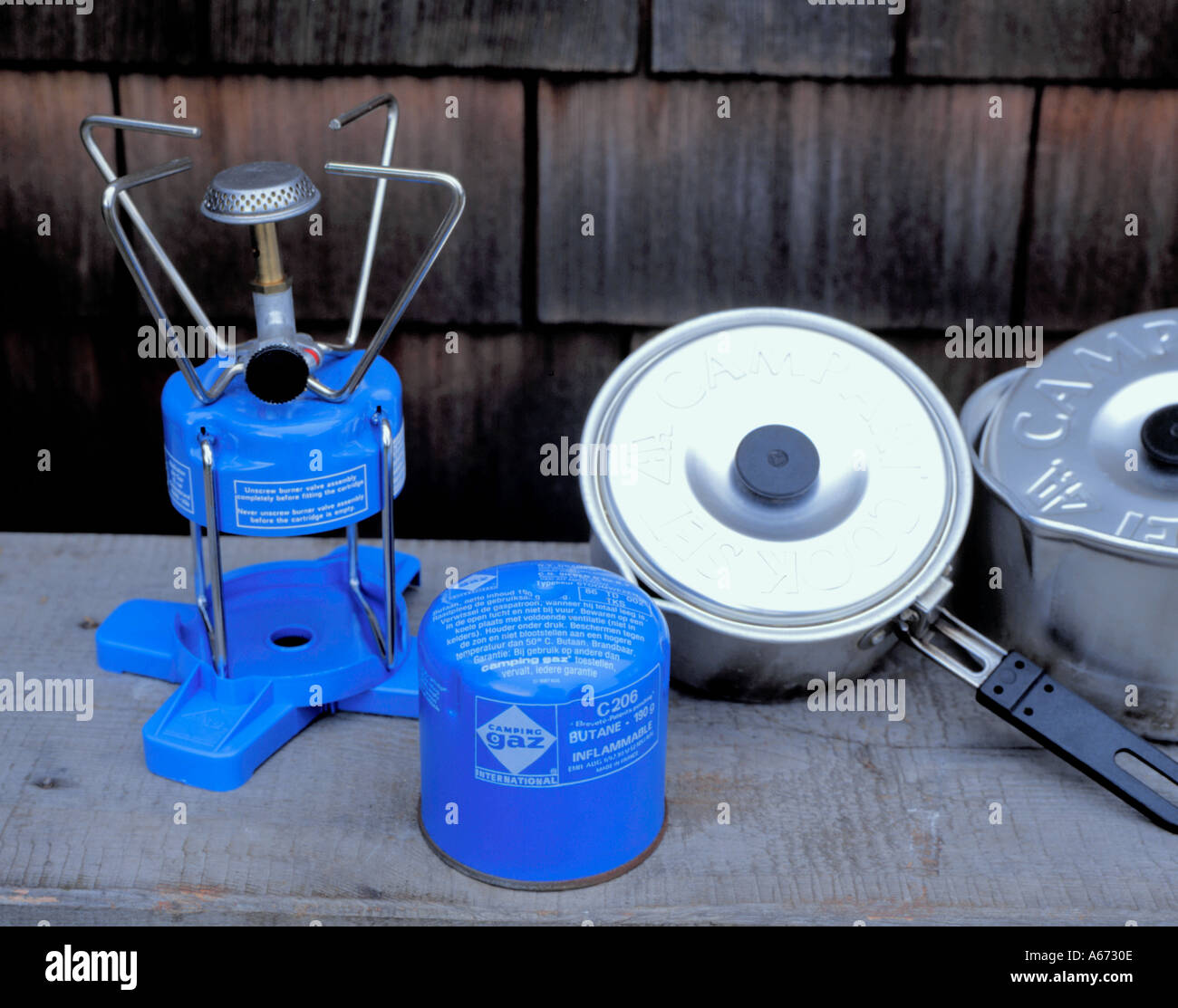 Camping gaz cooker (steel and plastic), gas cylinder (pressed steel) and  camping saucepans (aluminium and plastic Stock Photo - Alamy