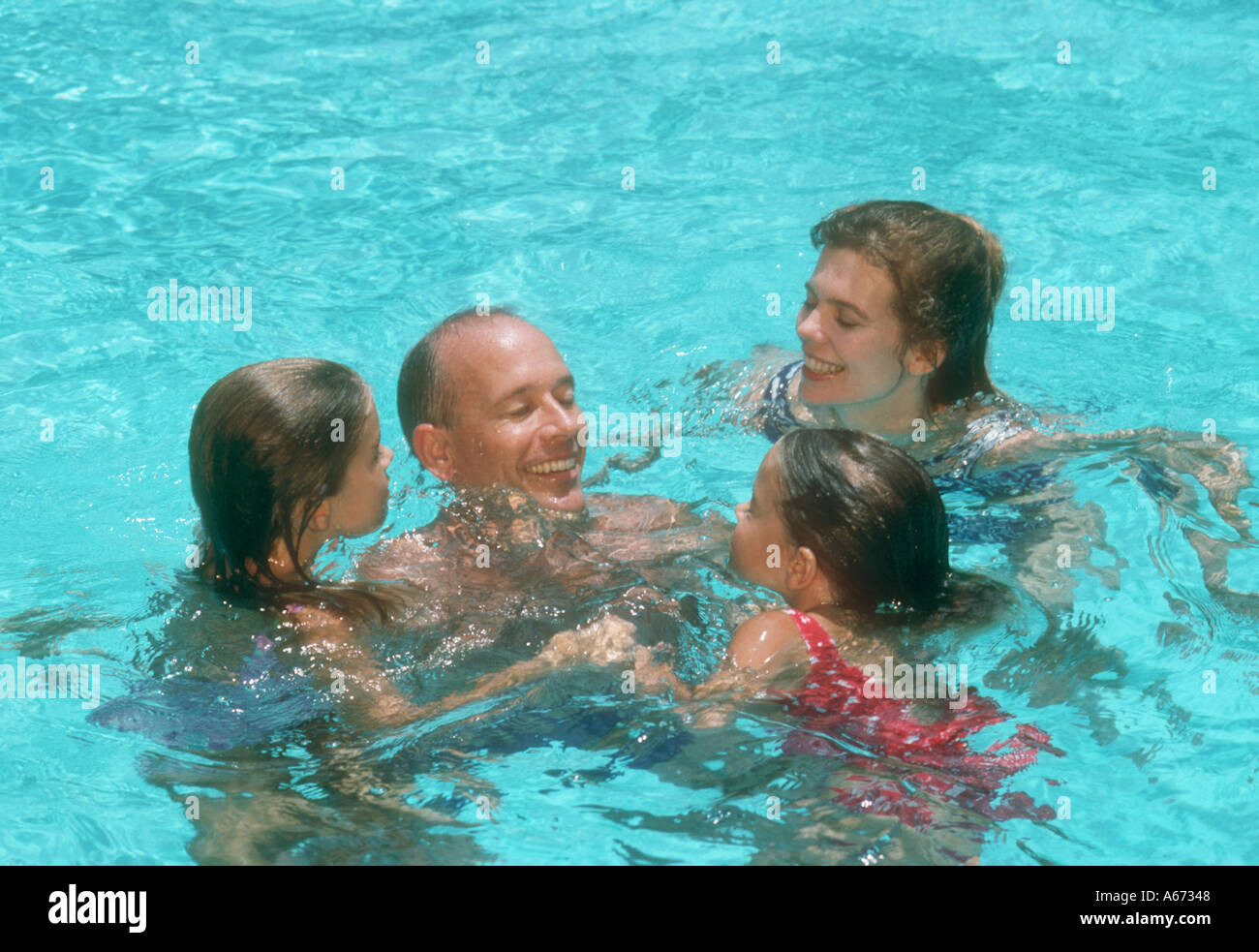 Family Of Four Playing In Swimming Pool Stock Photo Alamy family-of-four-playing-in-swimming-pool-stock-photo-alamy