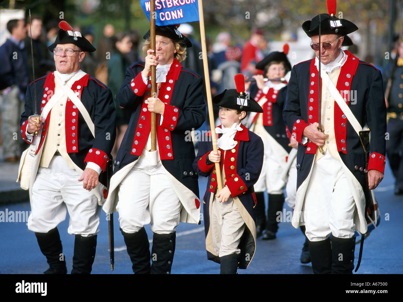 Men and a boy dressed in Revolutionary War costumes march in Veterans Day parade Stock Photo
