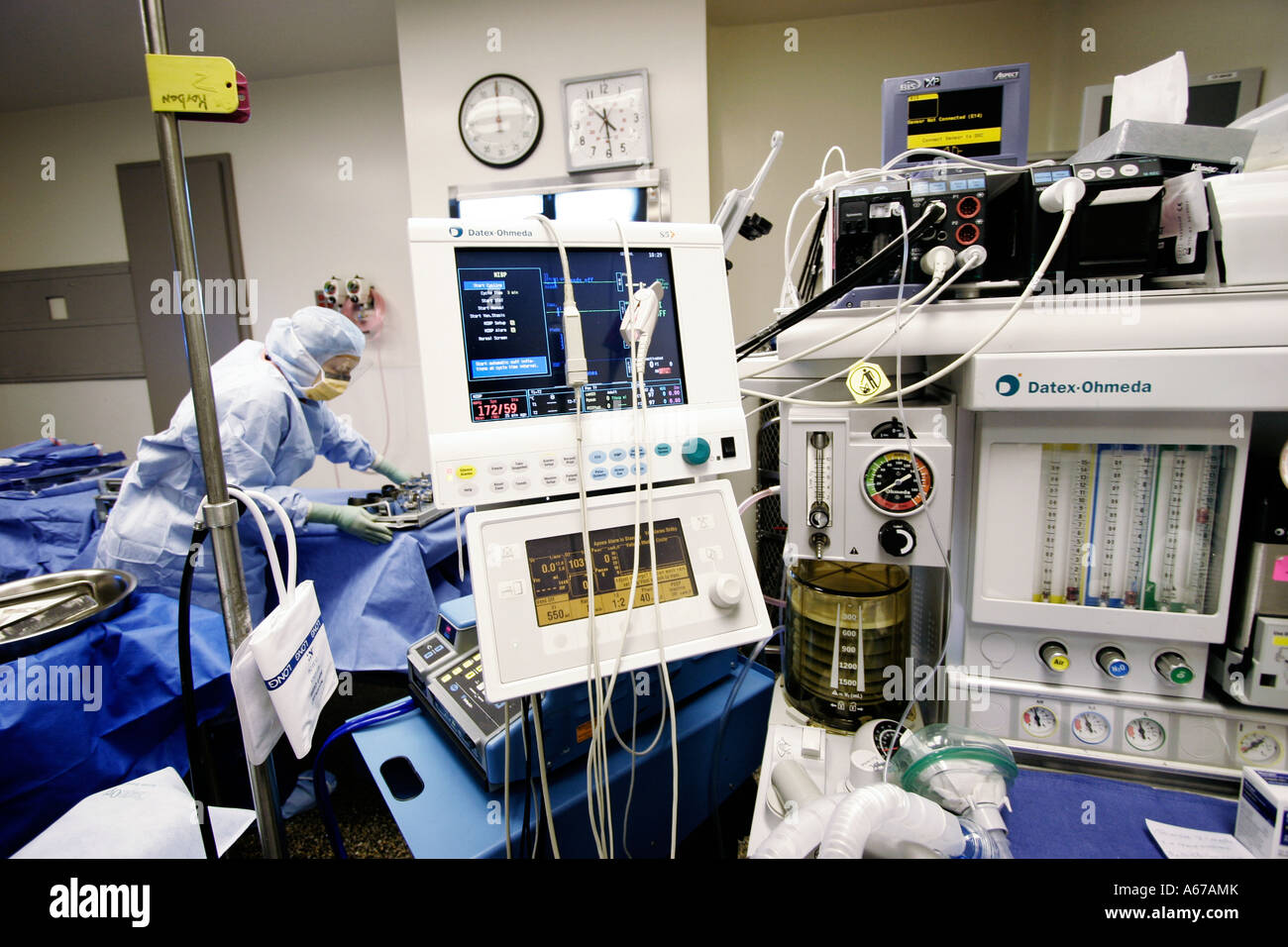 machines for monitoring vital signs and regulating dosages used by anesthesiologist in operating room Stock Photo