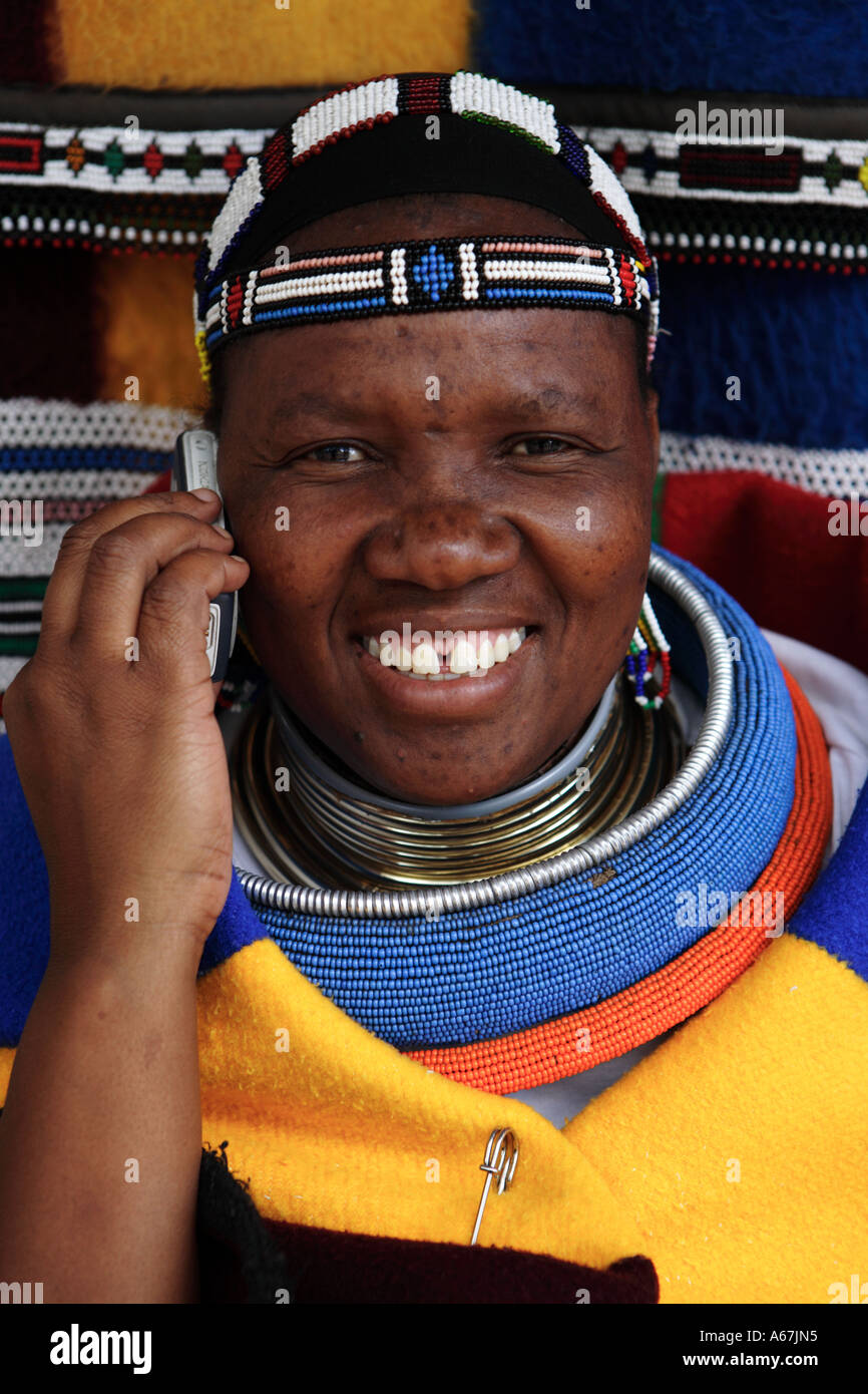 Ndebele woman in traditional dress on cell mobile phone Stock Photo