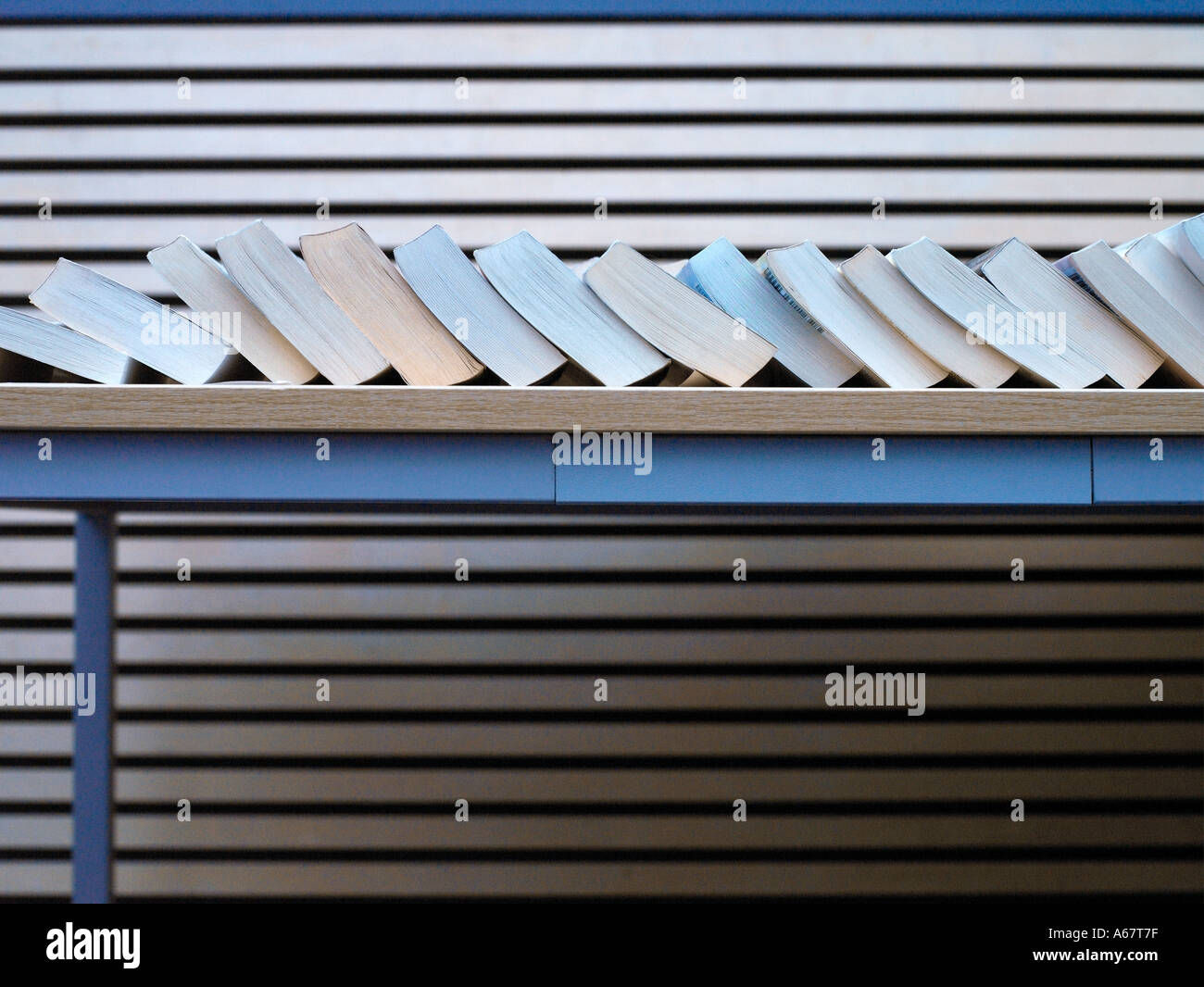 a row of book sitting on table Stock Photo