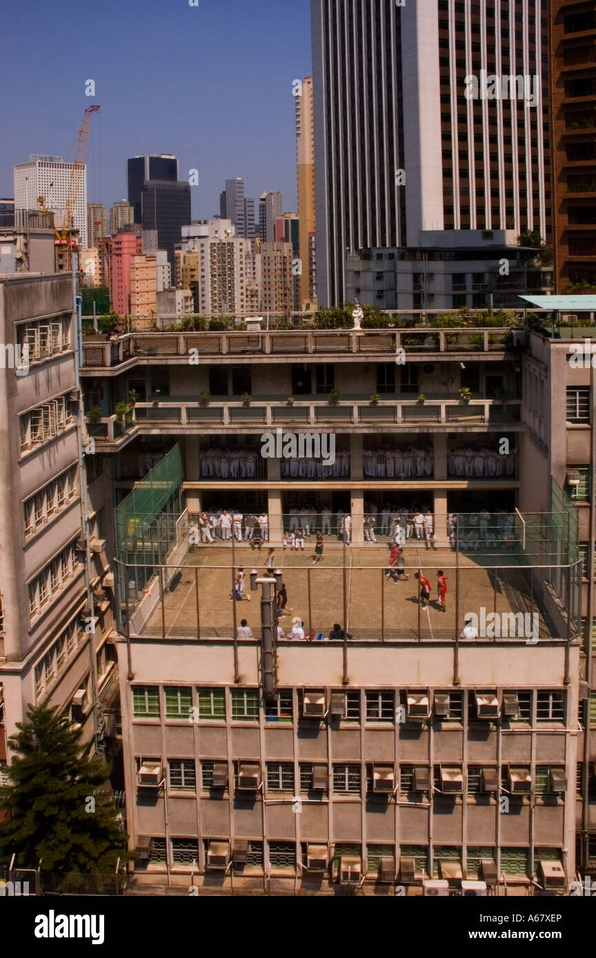 School boys play basketball on a highrise court, Hong Kong. 2006 Stock Photo