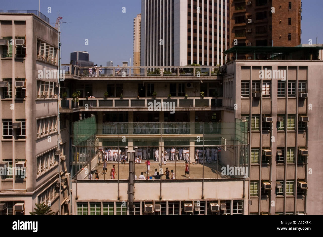 School boys play basketball on a highrise court, Hong Kong. 2006 Stock Photo