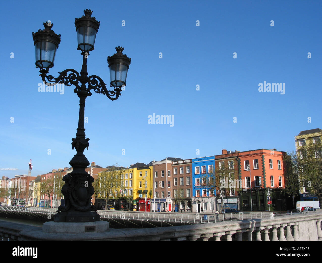 lamp post at O'Connell Bridge Dublin Ireland with view over colourful architecture of Bachelors