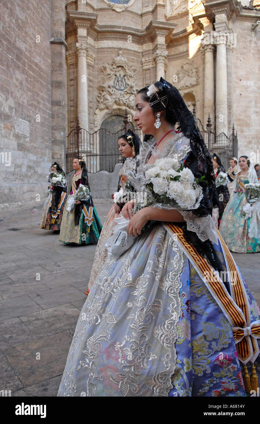 Falleras in traditional Valencian costume marching in the street during ...