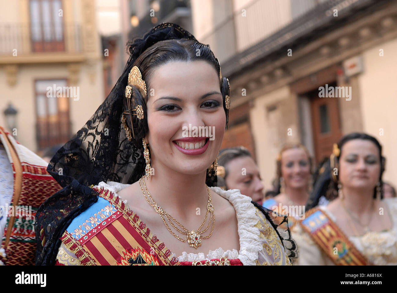 Spanish woman with elaborate spiralled buns on the side of her head, a ...