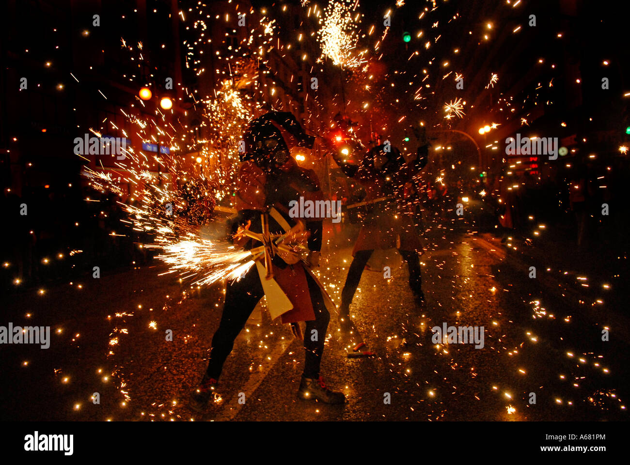 Falleros in red costume marching with sparklers during Cavalcada del ...