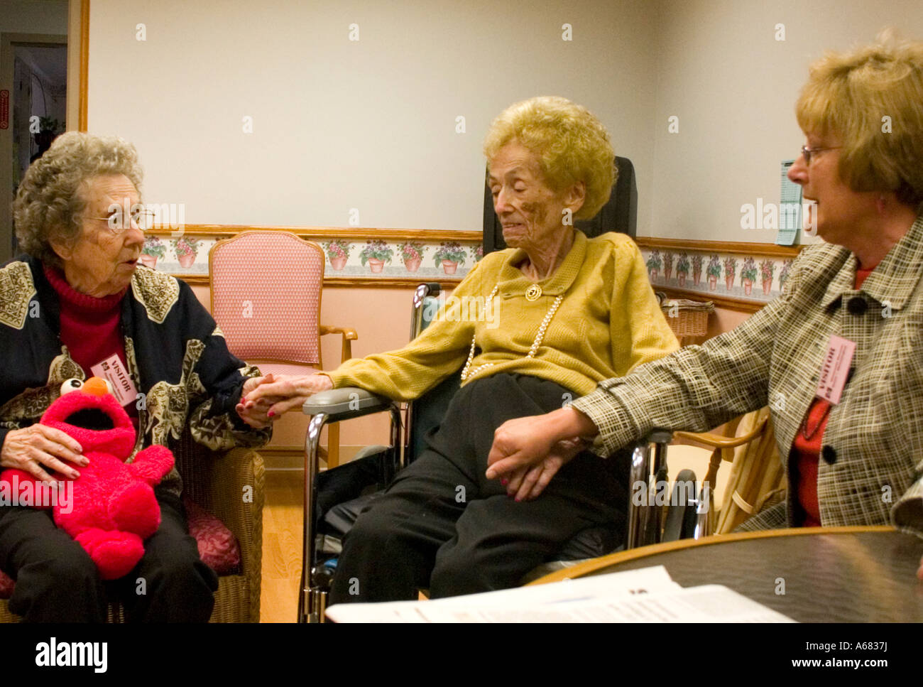 Sister and daughter comforting mom age 93 at nursing home during her