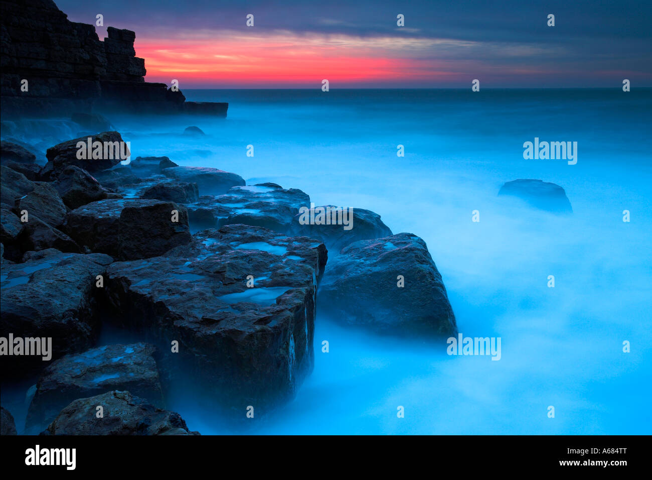 Intense pink glow in the skies above Winspit, Dorset Stock Photo