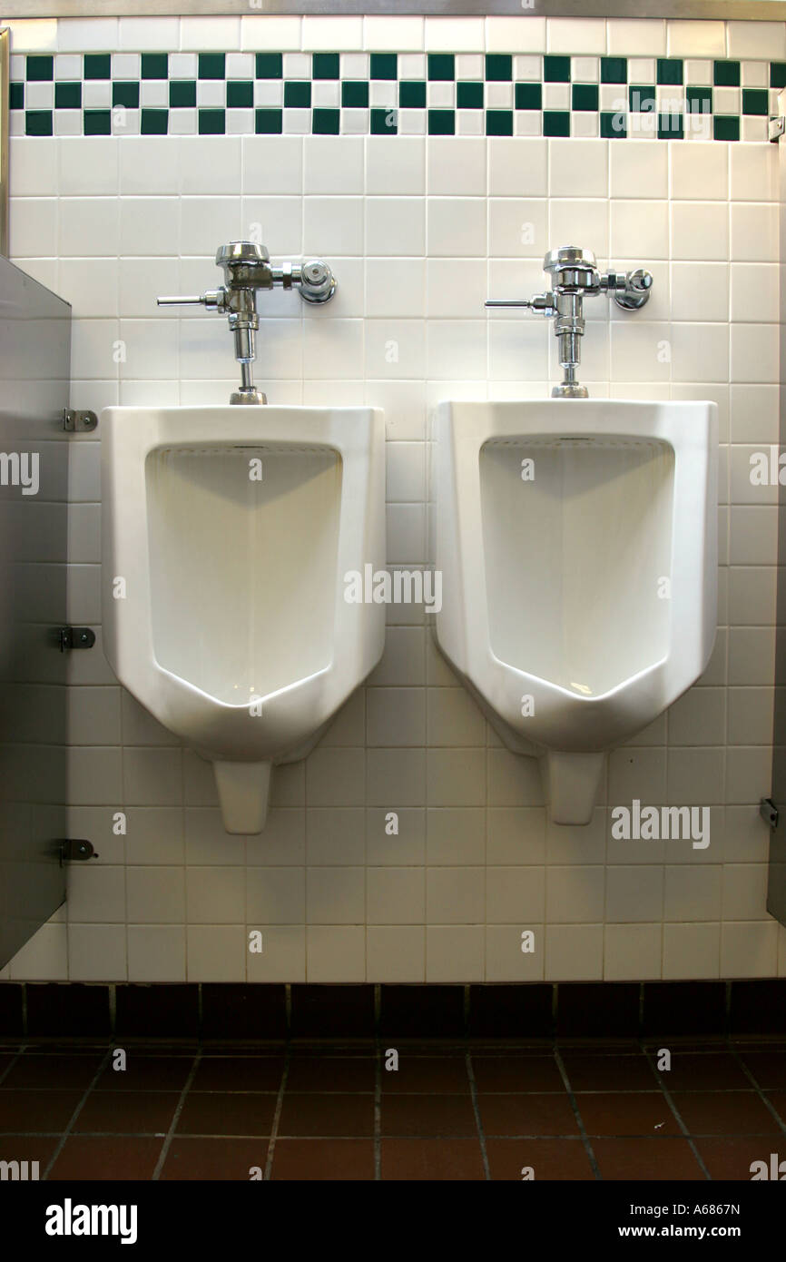 A pair of urinals inside a public restroom Stock Photo Alamy