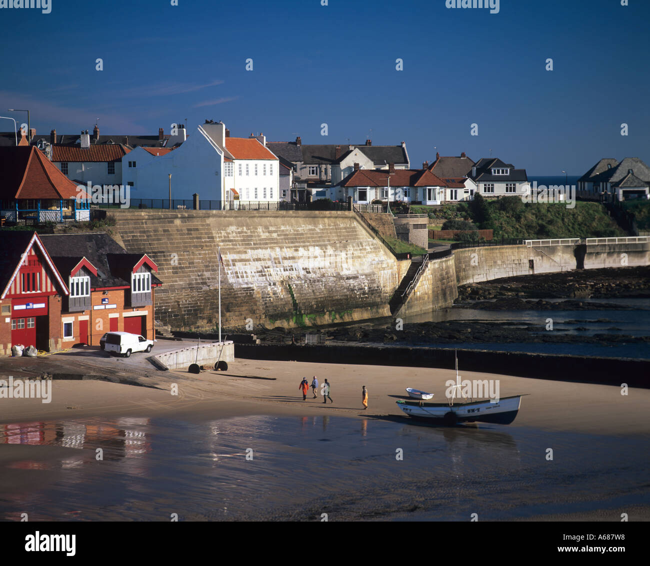 Fishermen launch traditional coble near the Old Lifeboat Station Cullercoats Tyne and Wear England UK Stock Photo
