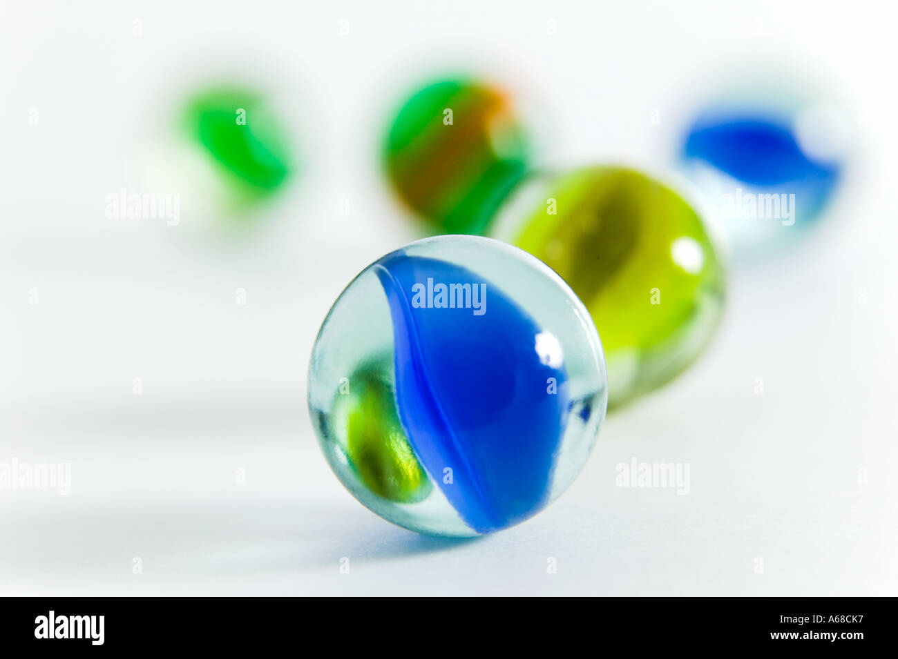 Brightly colored marbles against white background horizontal Stock