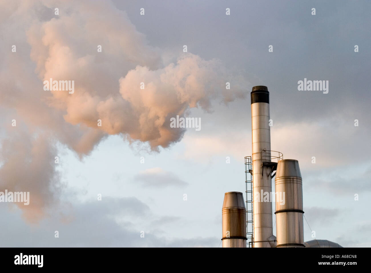 Chimney at Bradford factory belching out steam in early morning sun