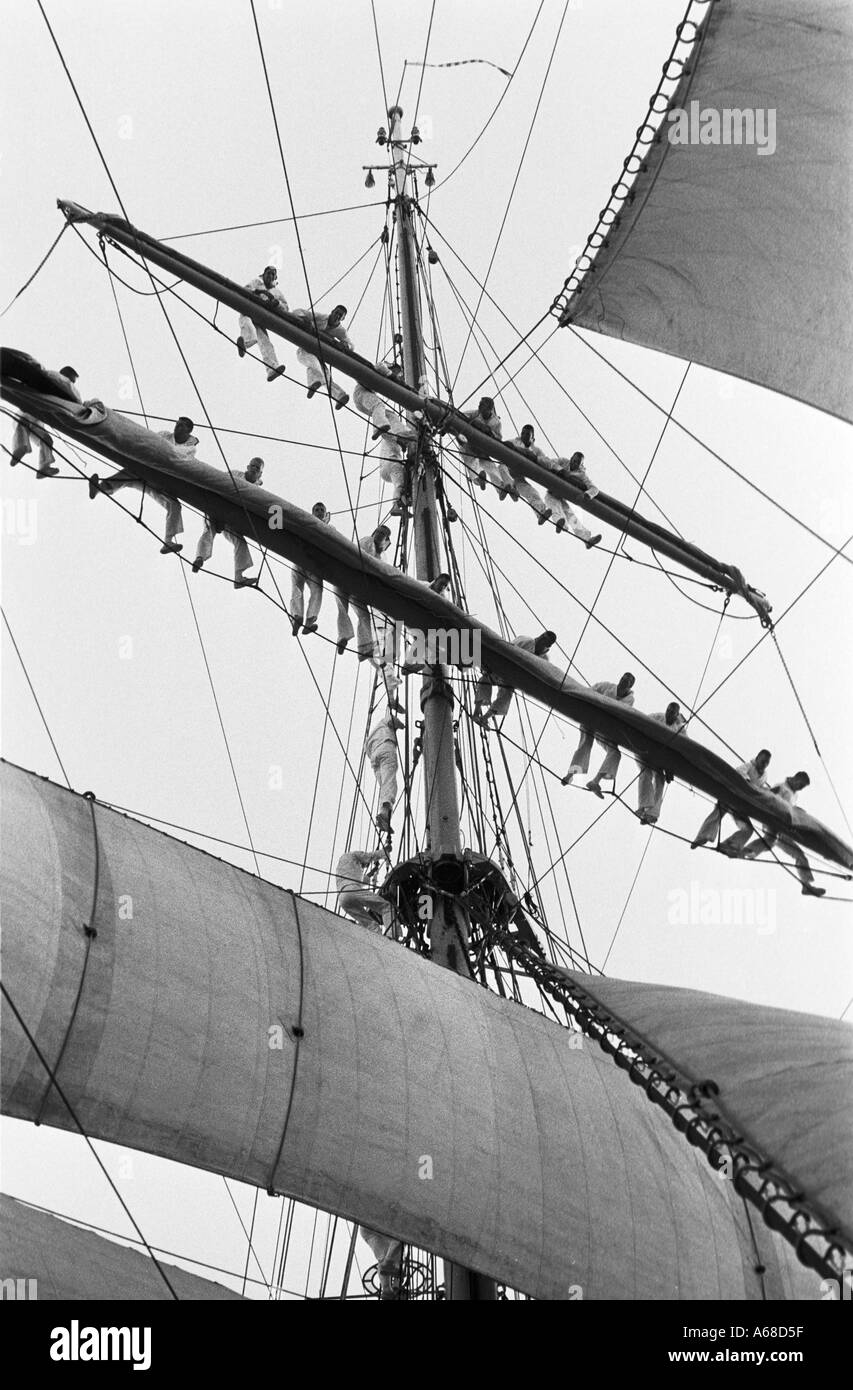 Cadets from the United States Coast Guard Academy aloft on a yardarm on the USCG Eagle training ship Stock Photo