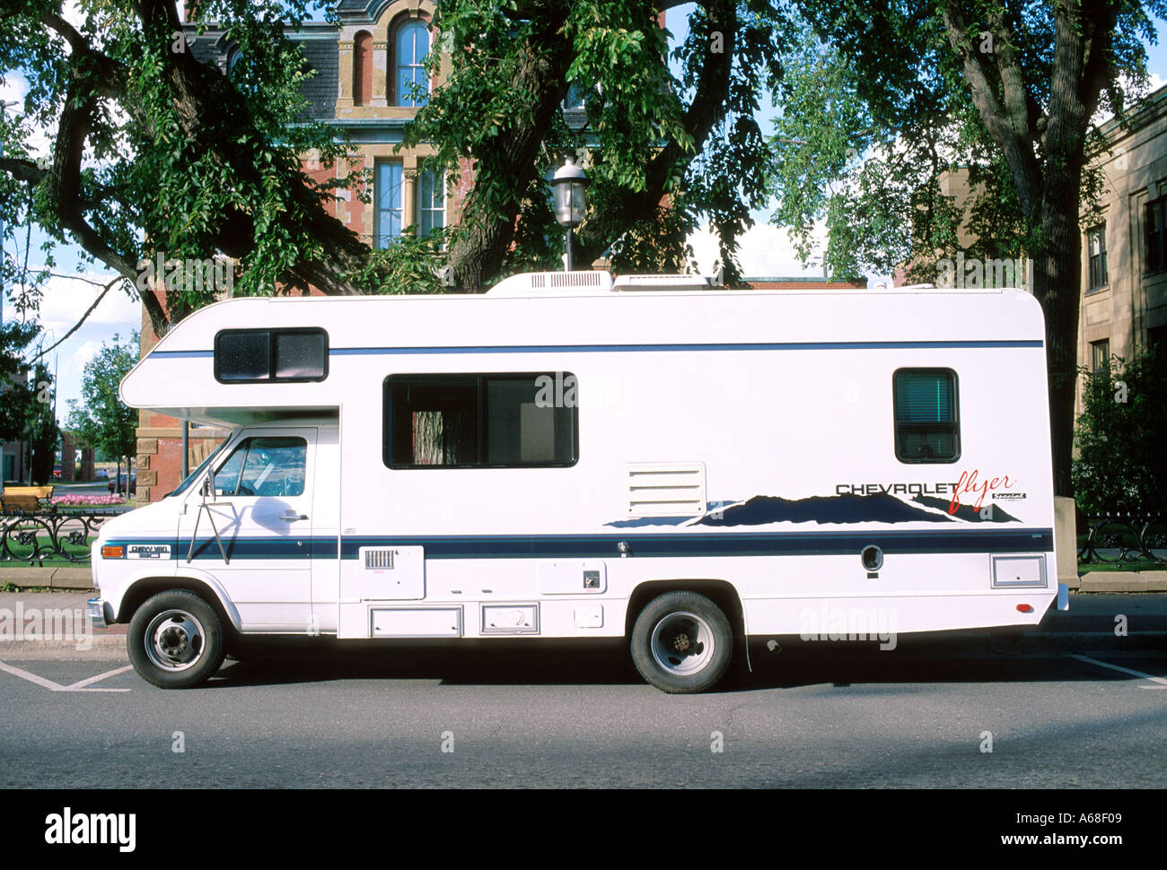 Caravan recreational vehicle parked on a city street Stock Photo