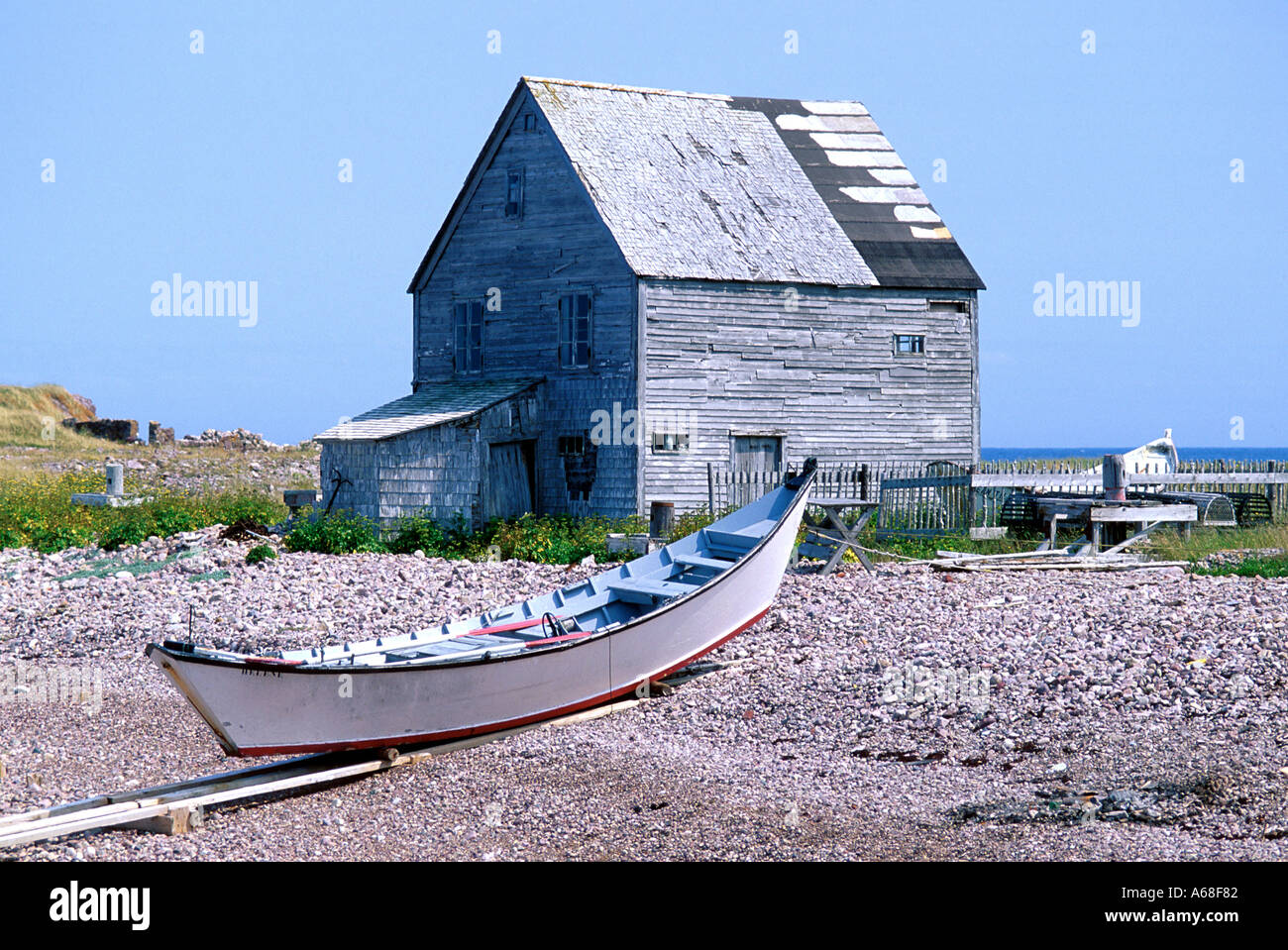 A fisherman's shack and a dory on the beach, Ile aux Marins, Saint Pierre et Miquelon Stock Photo