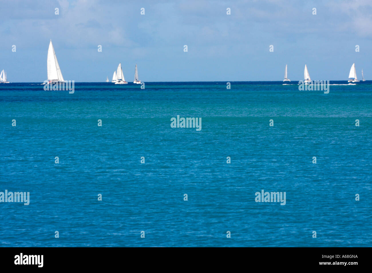 British Virgin Island Virgin Gorda Sound View of blue ocean with sail boats sailing in the distance Stock Photo