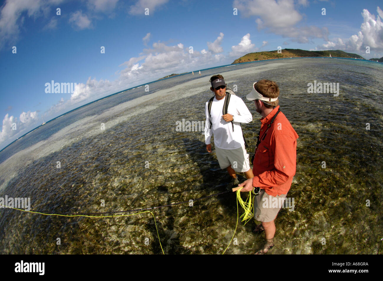 British Virgin Islands Caribbean Man with guide salt water fly fishing for bone fish on the