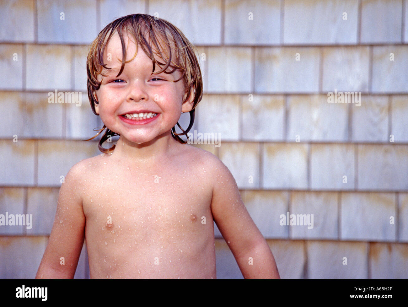 Happy boy in outdoor shower after the beach, Cape Cod , MA Stock Photo