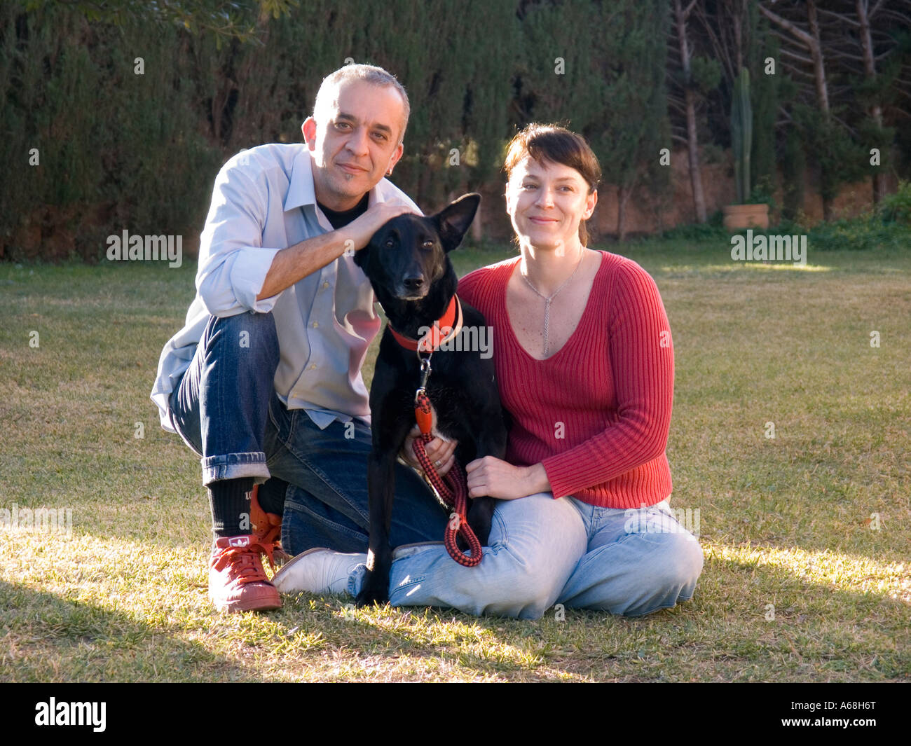 Portrait of a couple with dog Stock Photo - Alamy