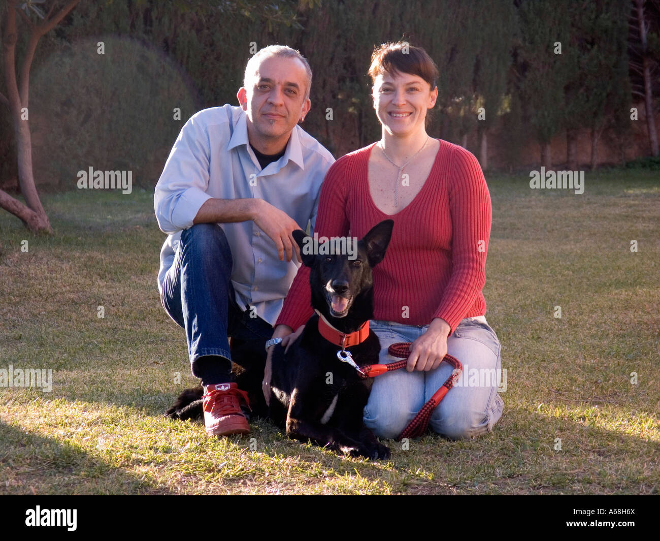 Portrait of a couple with dog Stock Photo - Alamy